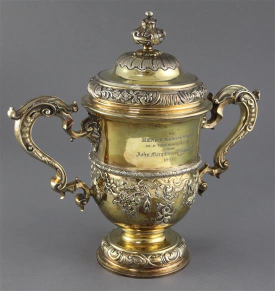 A George II silver gilt two handled presentation cup and cover by Thomas Whipham, 70.5 oz.